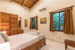 Cozy bedroom with a comfortable bed, large window, and ample storage.