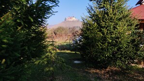 A view of a castle on a hill with a clear sky. - András pension (Krasnohorske Podhradie)