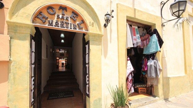 A hotel entrance with a sign reading "HOTEL SAN MARTIN".