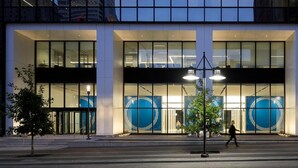 A modern building with large glass windows and a central entrance with a circular design. - Mint House Dallas Downtown by Kasa (Dallas)