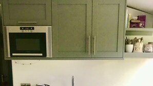 A kitchen with a microwave, toaster, coffee maker, and sink. - 30% Discount Beautiful converted studio apartment in idyllic Cotswold village! (Cirencester)
