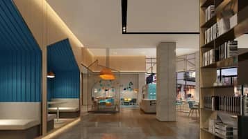 A modern interior with a central seating area, a bookshelf, and a view into an adjacent space.