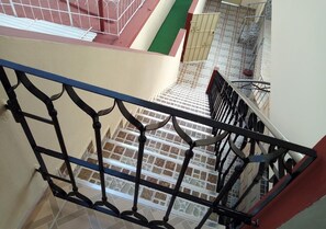 A staircase with metal railings and a tiled floor. - Hostal Betty SANTA MARTA (Cárdenas)