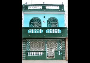 Experience the unique blend of traditional and modern architecture in this two-story building with a distinctive facade and ornate details.