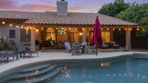A poolside area with a covered patio, outdoor seating, and a swimming pool. - Stunning North Scottsdale Home w/Heated Pool and Hot Tub (Scottsdale)