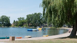 A lakeside park with boats, a playground, and a walking path. - Great Blue Resorts - Cherry Beach Resort (Prince Edward)