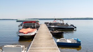 A wooden pier with several boats docked at the end. - Great Blue Resorts - McCreary's Beach (Drummond-North Elmsley)