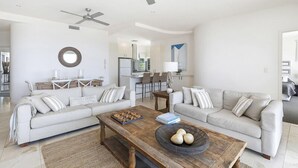 A modern living room with two sofas, a wooden coffee table, and a ceiling fan. - Relax in stylish comfort, Sunshine Beach (Sunshine Beach)