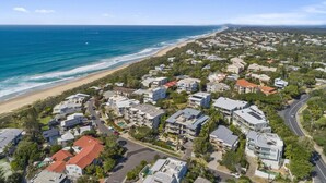 An aerial view of a coastal residential area with houses, a beach, and a clear sky. - Relax in stylish comfort, Sunshine Beach (Sunshine Beach)