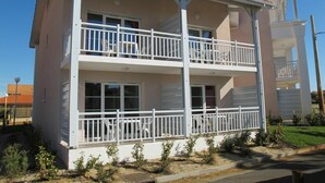 A two-story building with a balcony on the second floor.