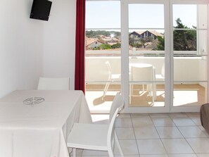 Enjoy a room with a balcony offering a view of the surrounding residential area.