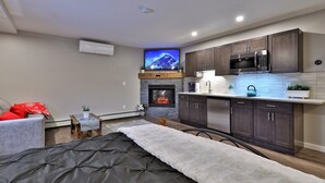 A modern kitchen with dark cabinets, a microwave, and a built-in oven.