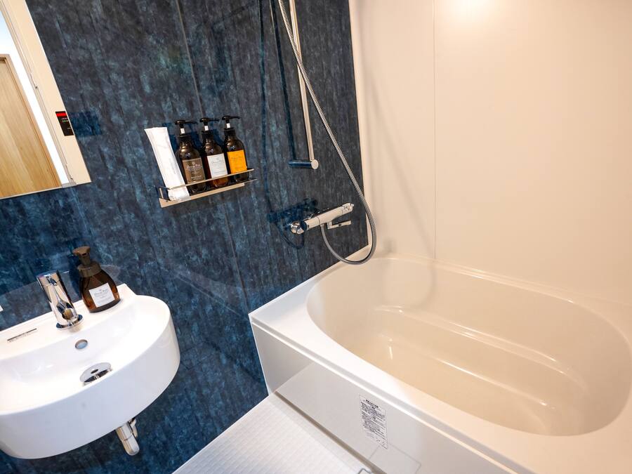 Un baño moderno con una bañera blanca, un lavabo y una ducha.