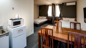 A compact hotel room with a kitchenette, a bed, a sofa, and a dining area. - Hotel R9 The Yard Yaita (Yaita)