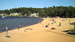 Guests can enjoy a beachside stay with access to the ocean, a lifeguard on duty, and scenic views of nearby houses and boats.