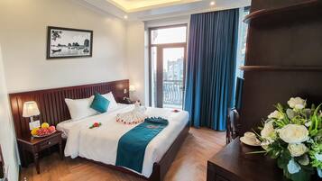 Enjoy a restful stay in this inviting room featuring a comfortable bed, bedside table, and a charming view.