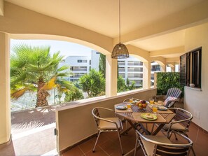 Enjoy meals al fresco with a view of the surrounding greenery from this balcony.