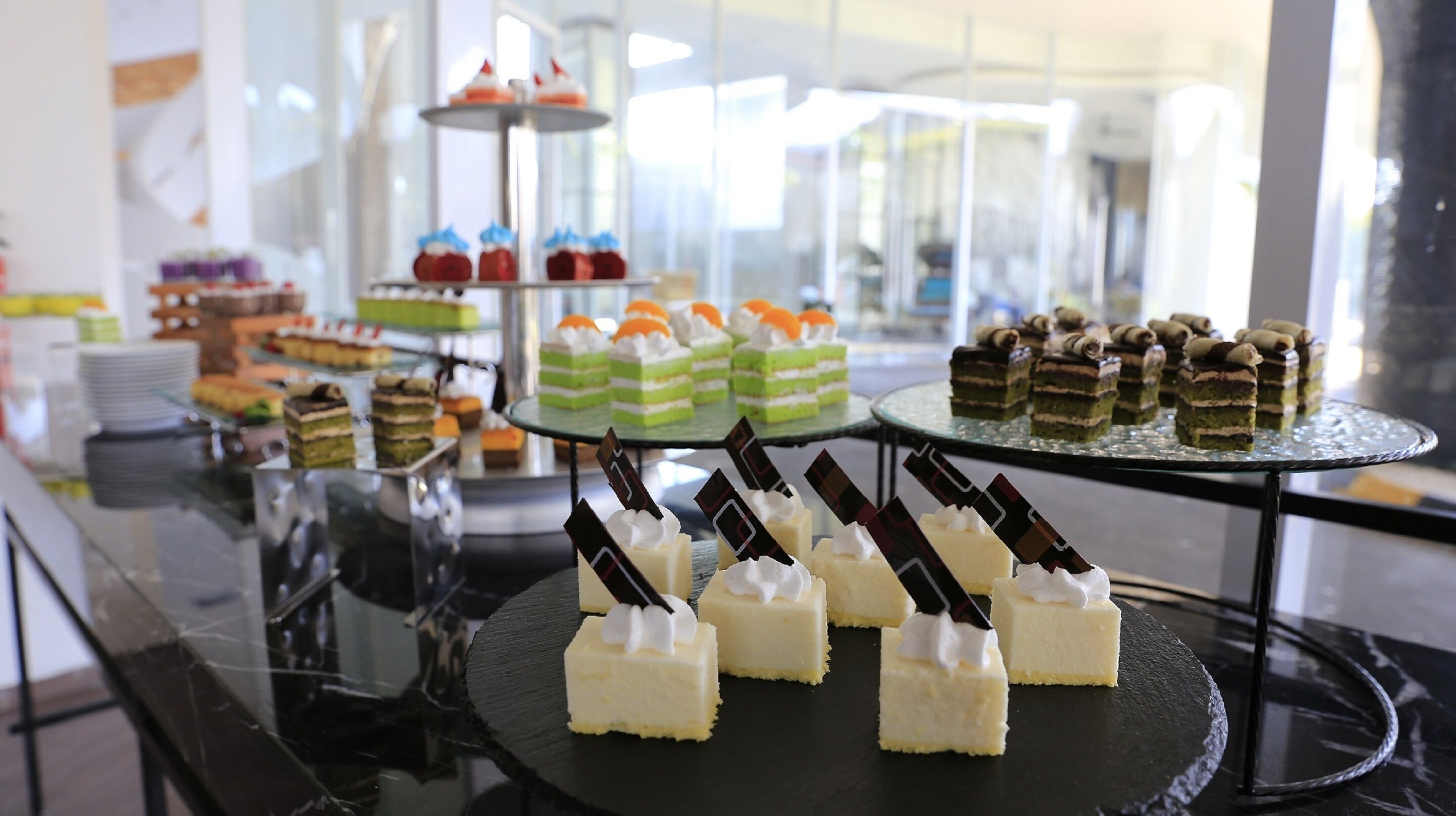 A buffet with various desserts and cakes on display.