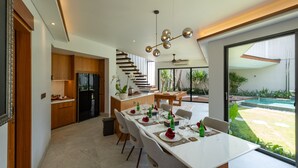 A modern kitchen with wooden cabinets and a built-in stove.