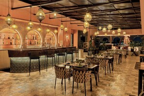 A restaurant with a bar area, multiple seating arrangements, and hanging decorative lights. - The Fern Kolhapur, Series by Marriott (Kolhapur)