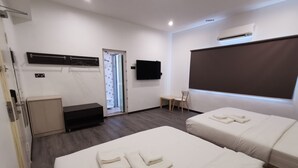 A hotel room with two beds, a TV, a desk, and a chair. - TT Dorf Hotel Matang (Taiping)