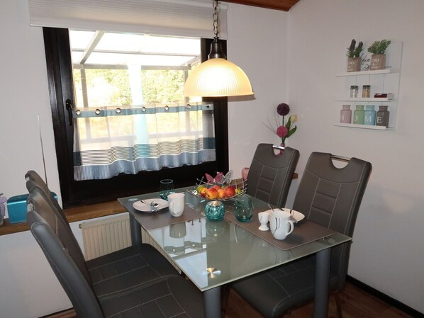 Enjoy meals in this stylish dining area with a glass-top table and comfortable seating for four.