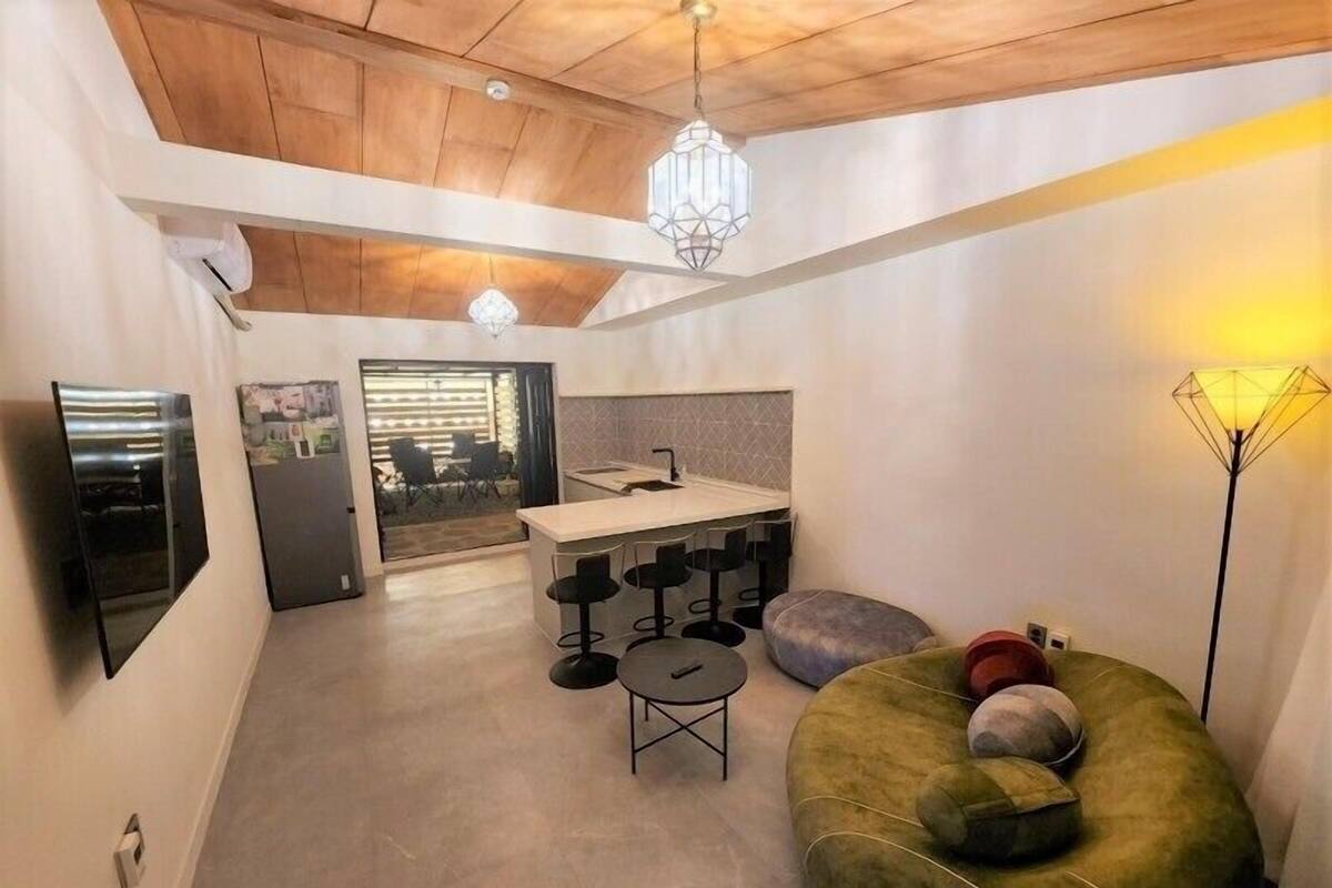 A modern interior with a kitchen, dining area, and a cozy seating space.