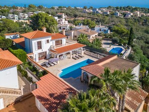 A large villa with a swimming pool, multiple balconies, and a view of the surrounding residential area. - Beautiful private villa for 6 people with private pool, A/C, WIFI, TV, terrace and panoramic view (Manacor)