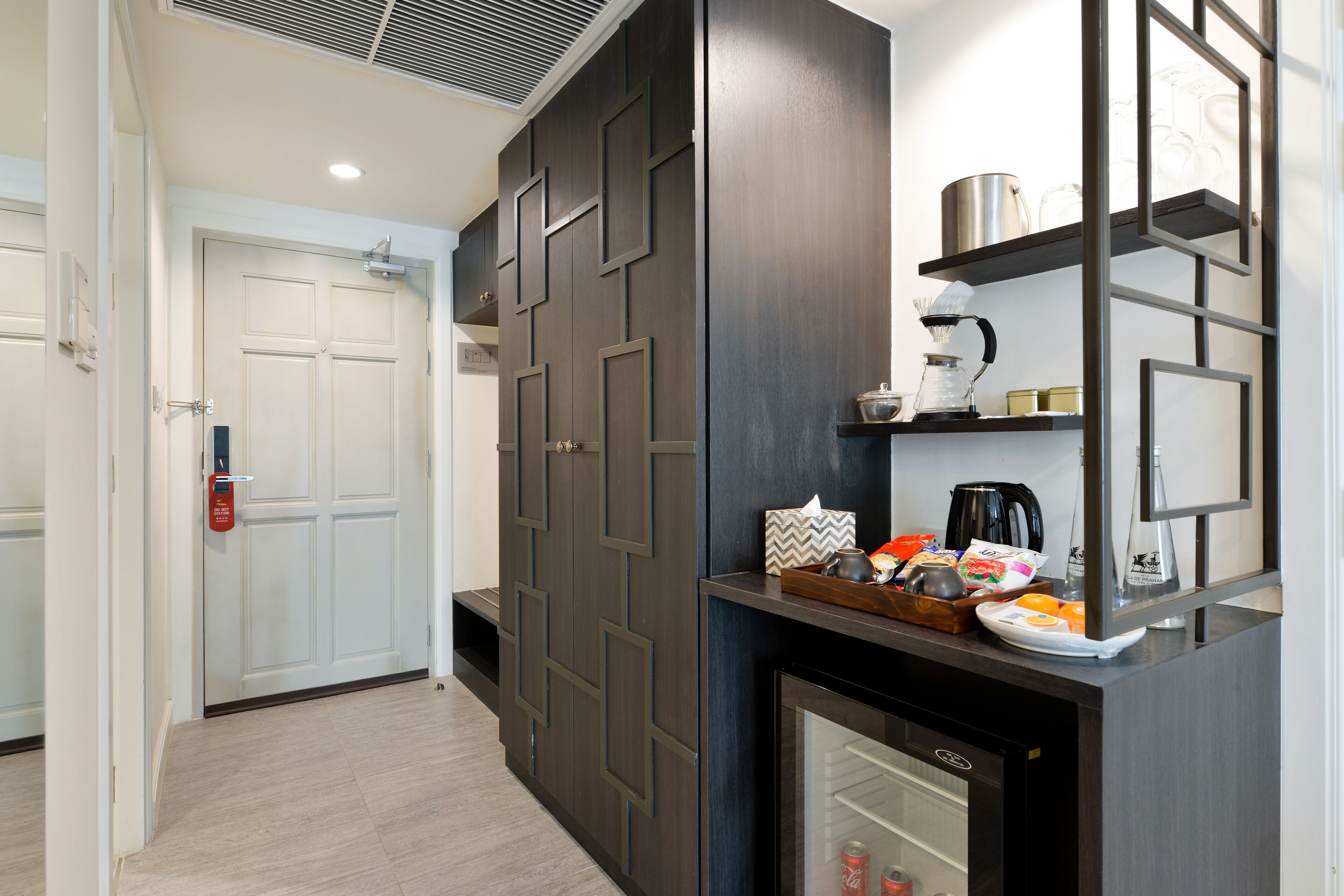 A modern kitchen with a built-in refrigerator, a coffee machine, and a microwave.