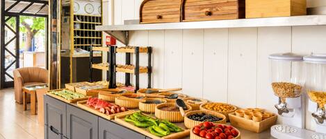 A buffet setup with various food items and utensils.