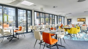 A modern dining area with large windows, contemporary furniture, and a clean, bright atmosphere. - Les Patios de Saint-Pierre (Palavas-les-Flots)