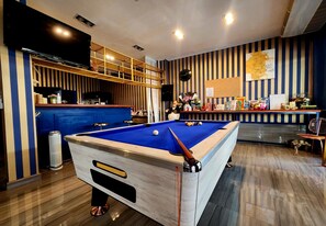 Relax and unwind in this well-appointed space, featuring a pool table, flat-screen TV, and cozy seating area.