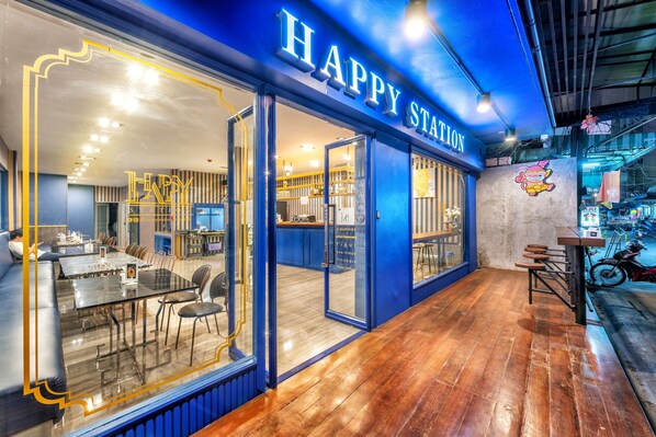 A restaurant with a blue exterior and a sign that reads "HAPPY STATION". - Happy Station Bangkok (Bangkok)