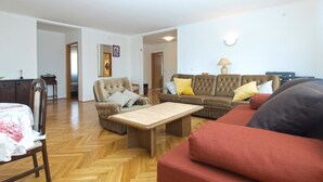 A living room with a sofa, armchair, and a small table. There is a door leading to another room. - Apartment 1624/16704 (Istria - Novigrad), 600m from the beach (Novigrad)