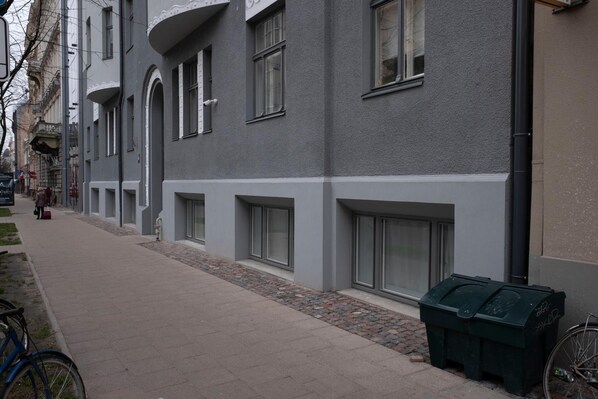 A building with a modern facade, large windows, and a paved walkway. - Hotel Saida - quality hostel (Riga)