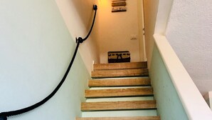 A staircase with wooden steps and a light blue wall.