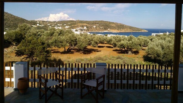 A terrace with a view of a coastal landscape, including olive trees and a distant sea. - Evdokia Studios (Sifnos)