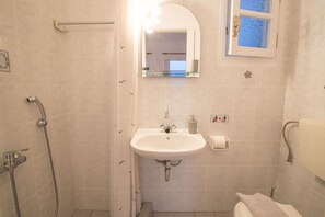 Comfort Studio | Bathroom | Shower, towels, toilet paper - Evdokia Studios (Sifnos)