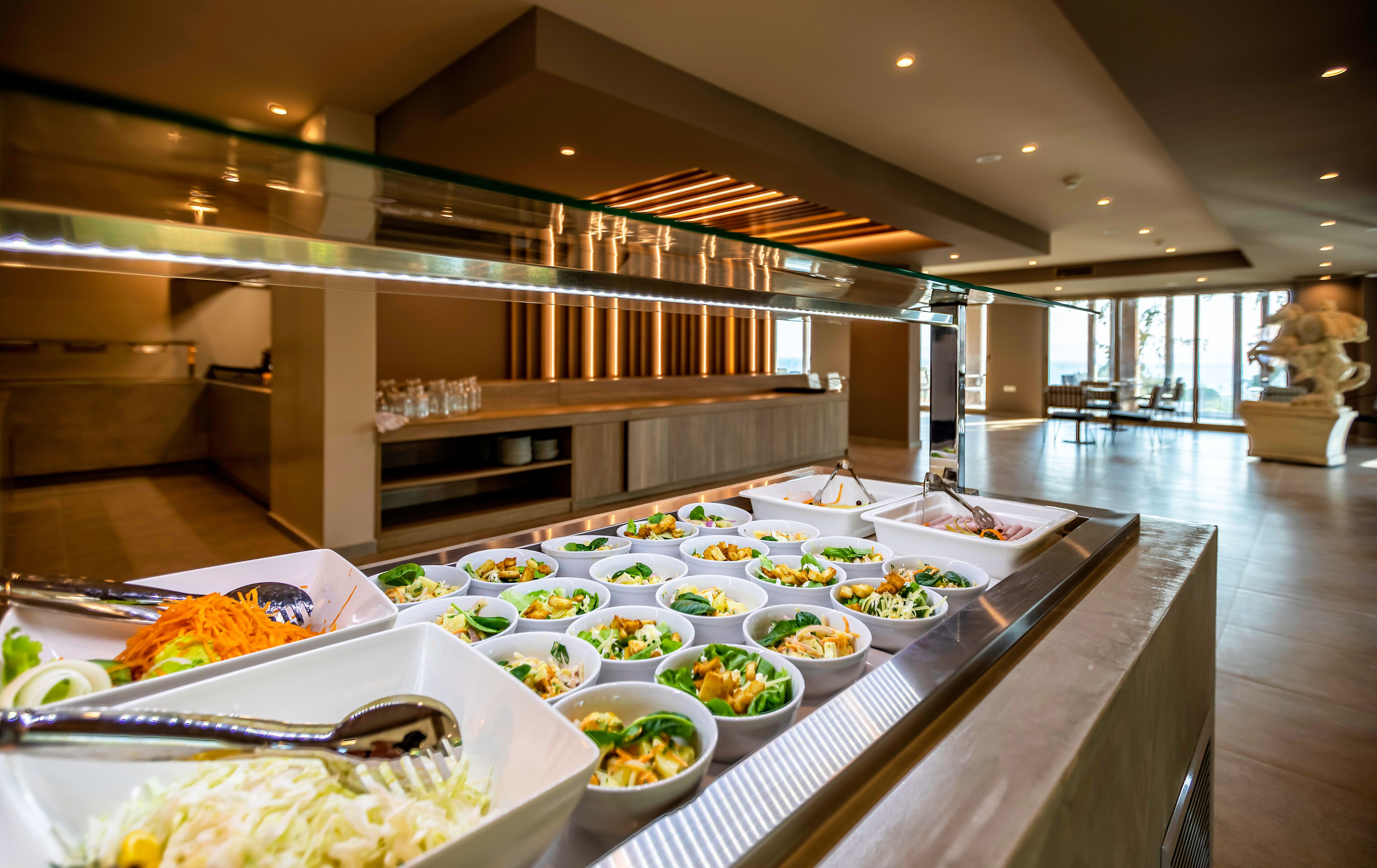 A buffet with various dishes and utensils.