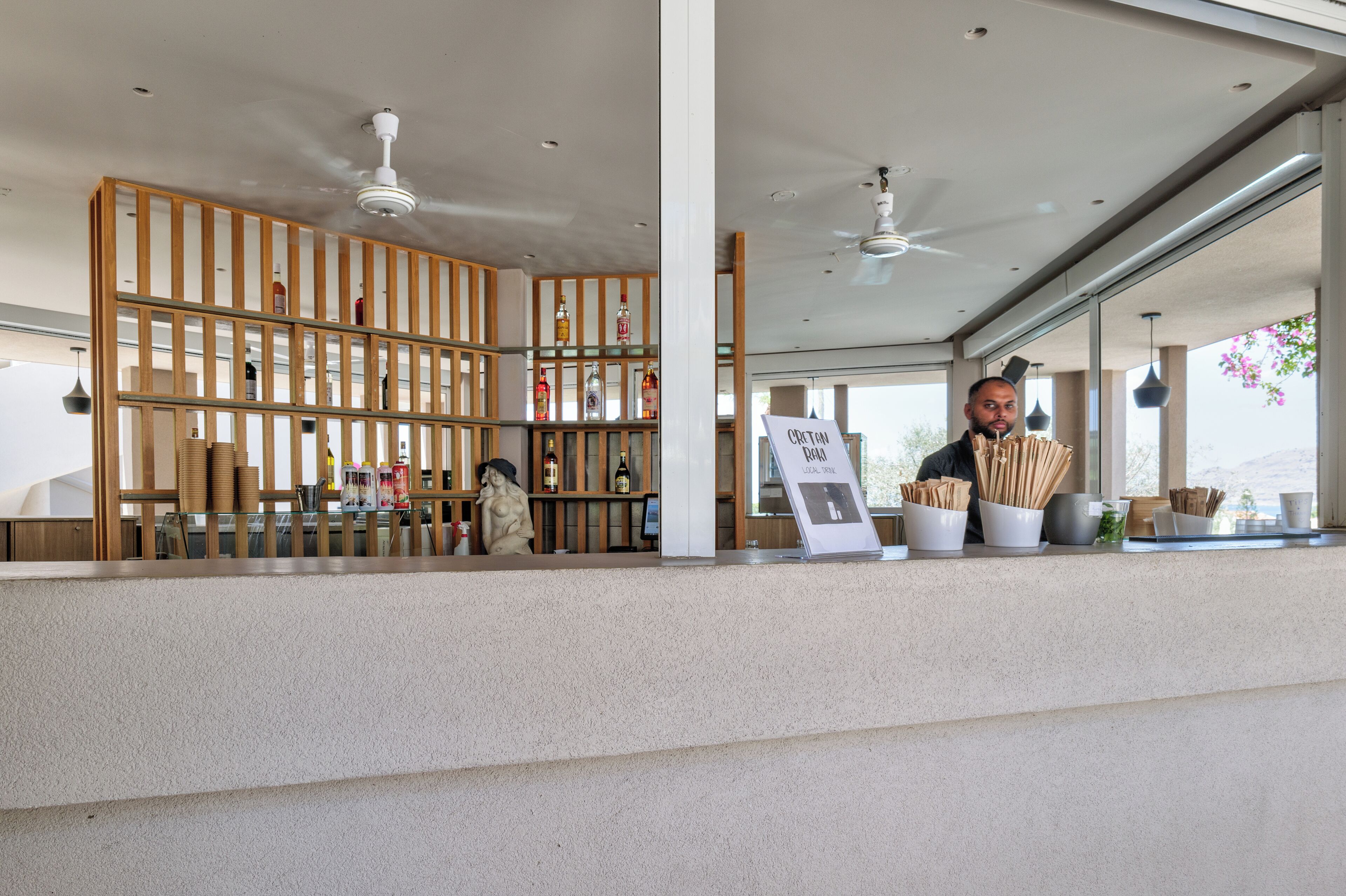 A reception area with a wooden partition, a counter, and a signboard.