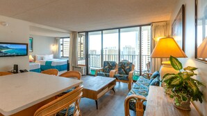 A hotel room with a balcony, a dining area, and a sofa set. - Block to Beach! Koko Resorts at the Waikiki Banyan 22nd Floor Pool View, Free parking & Wifi (Honolulu)