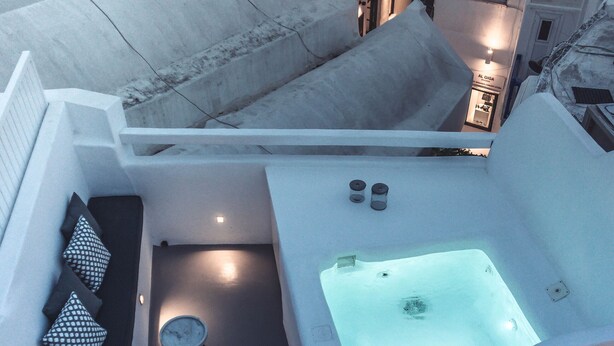 A rooftop terrace with a hot tub, seating area, and a small table. - Roofs of Chora, Townhouse with Rooftop Pool - Adults Only (Mykonos)