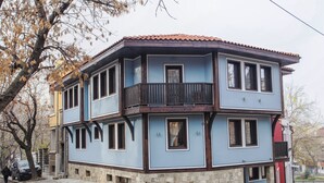 A two-story building with a balcony on the second floor.