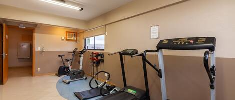 A gym with treadmills, an elliptical, and a stationary bike.