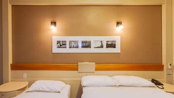 Deluxe Triple Room | Minibar, in-room safe, desk, iron/ironing board