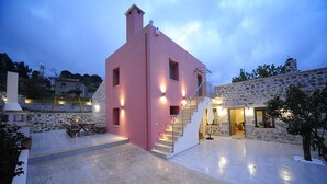 A modern building with a pink facade, a stone exterior, and a staircase leading to an upper level. - Hawk Villa, Timeless Village Escape with Pool (Gerakari, Rethymno)
