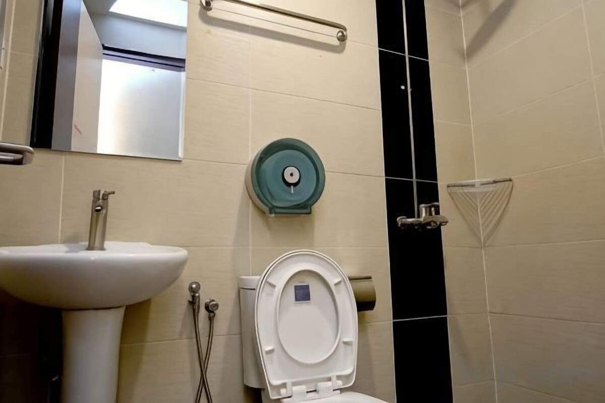 A bathroom with a sink, toilet, and a towel rack.