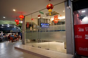 A restaurant with a glass entrance, red lanterns, and a sign for 'Pavilion'.