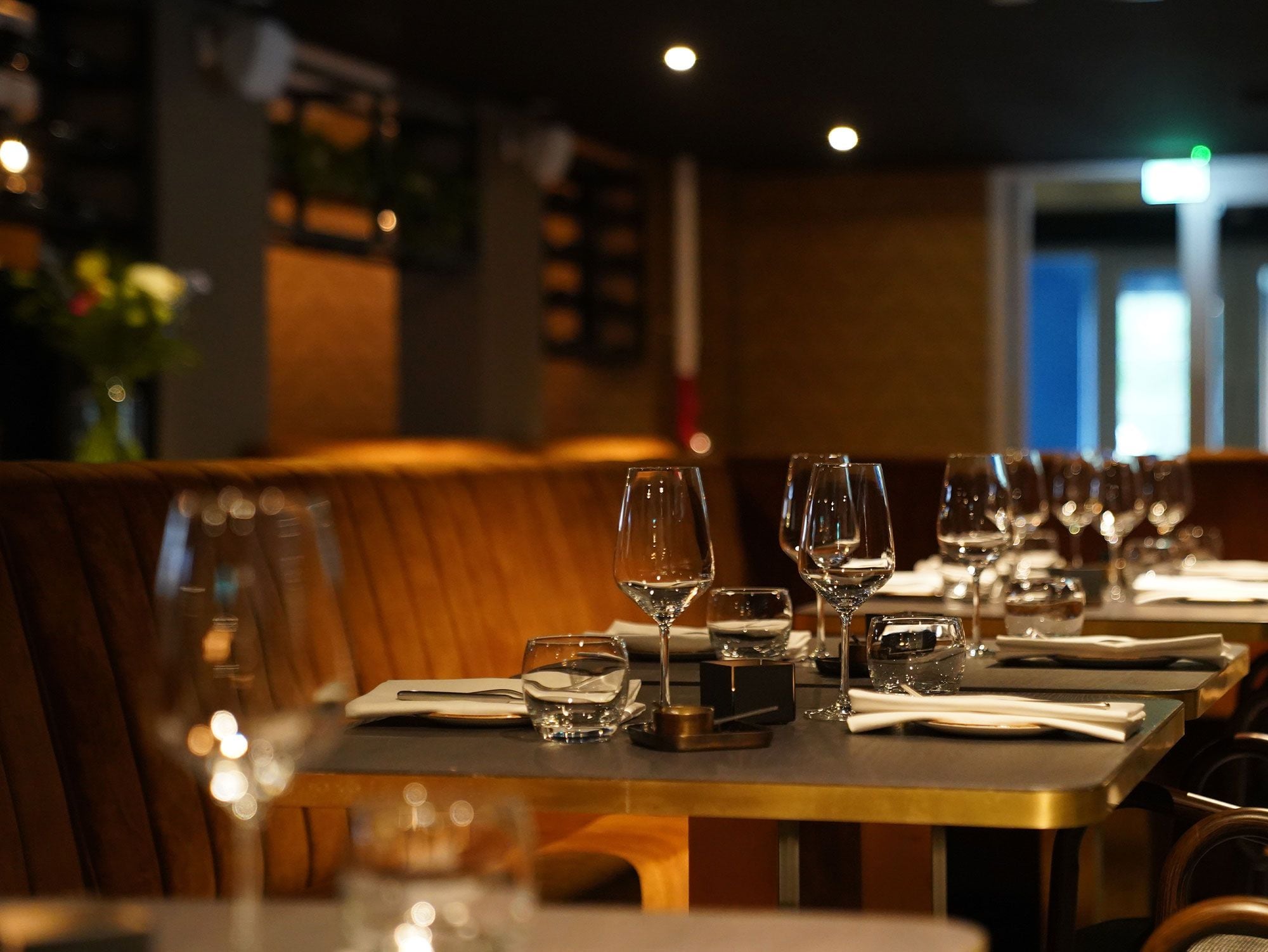 A restaurant dining area with booths and tables set for service.