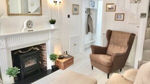 A living room with a fireplace, a brown armchair, and a beige sofa. - * SEE OVER 170 AMAZING GUEST REVIEWS ON AIRBNB * Location * Location * Location (Poole)
